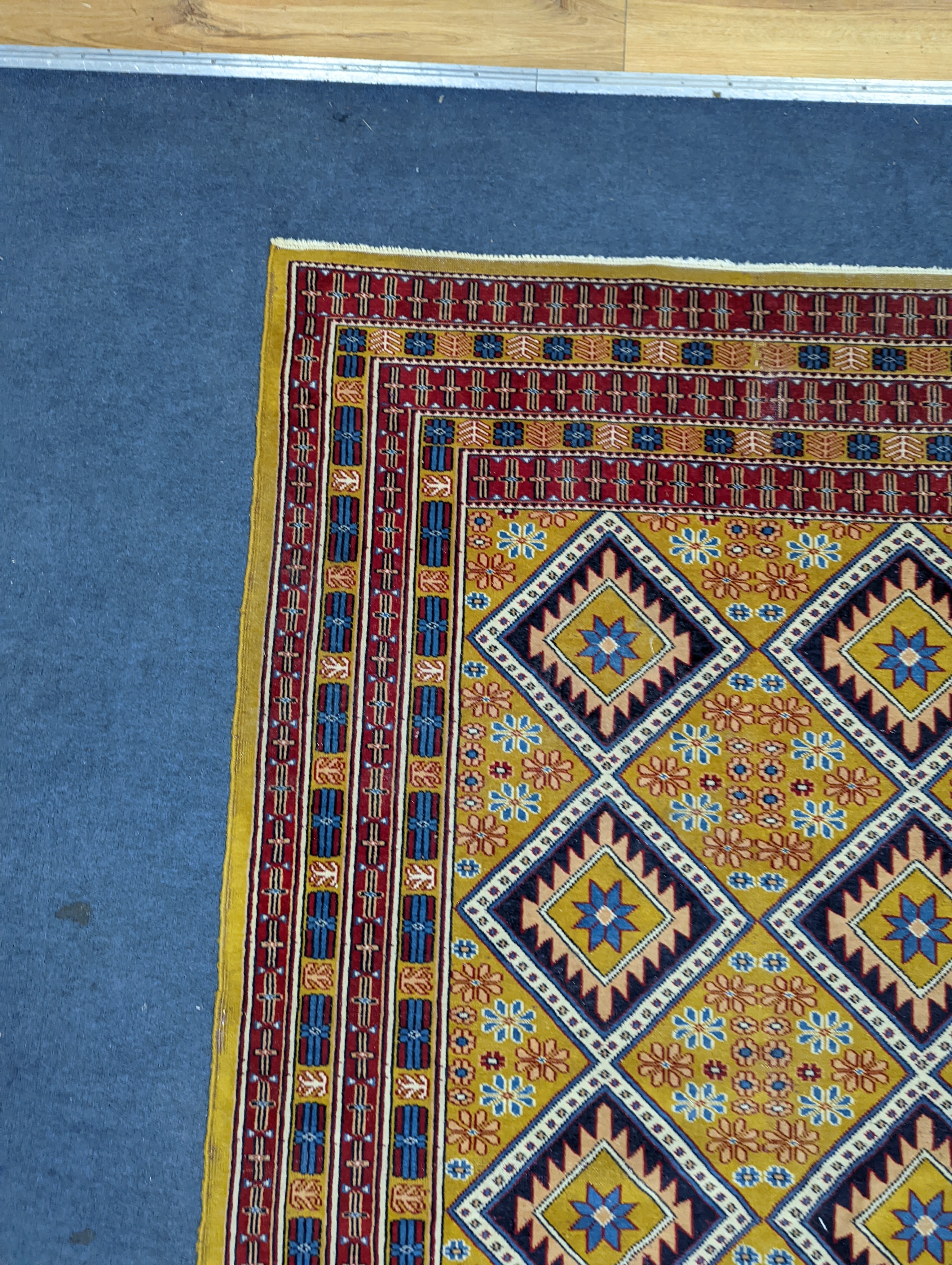 A Caucasian style gold ground rug, 190 x 124cm